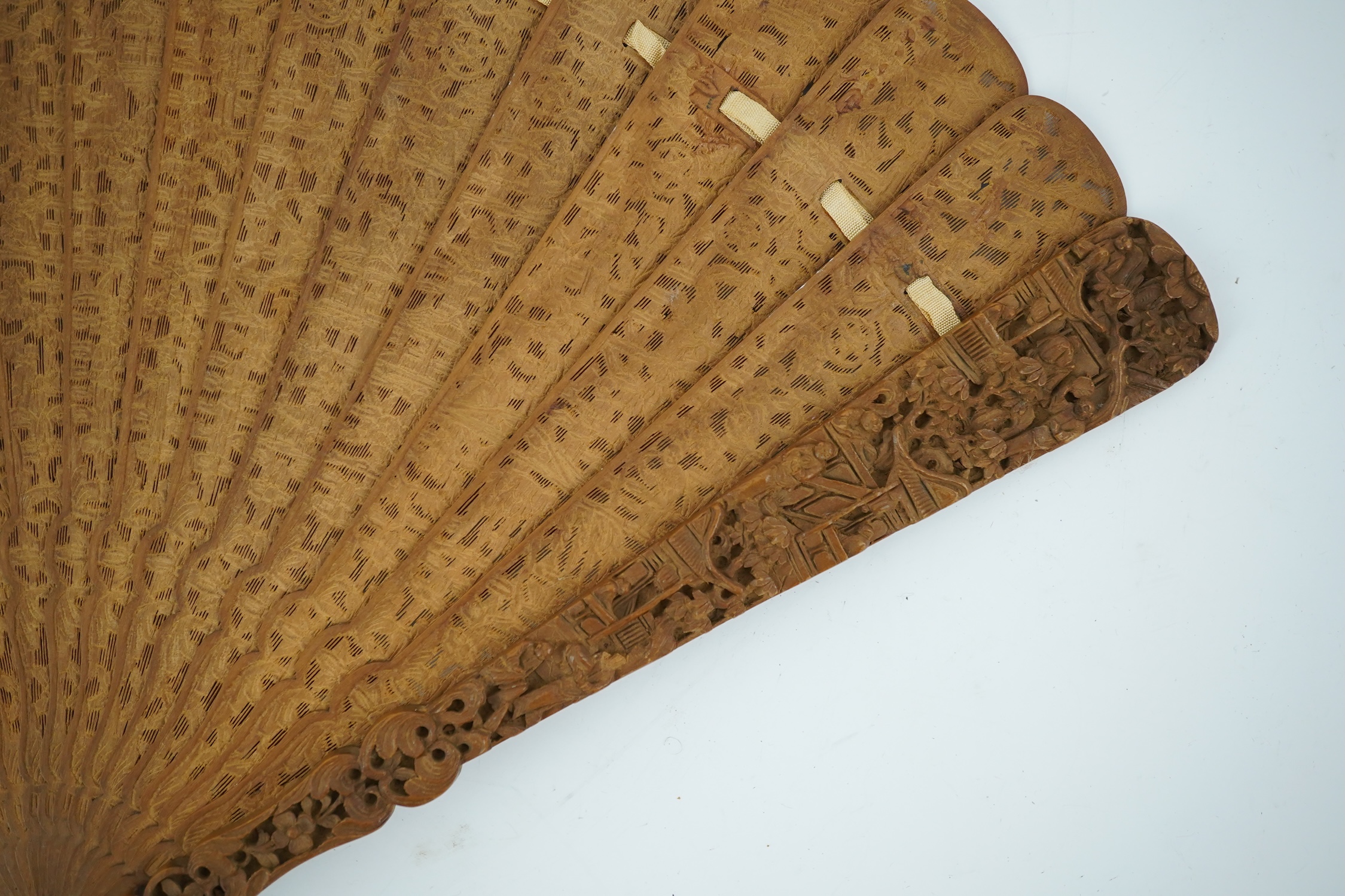 A fine Chinese sandalwood brise fan with finely carved sticks and guards, together with a mid 20th century silk calligraphic poetry LuYou fan, brise fan 38cm wide. Condition - minute damage to carving on one stick, sanda